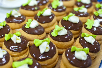 Production of pralines at confectionary factory. Food industral cake line - conveyor belt with sweets.