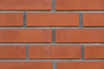 Obraz premium Orange background with grey geometric patterns. Red wall of rectangular stones, bricks, tile. Brickwork