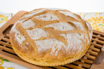 Freshly baked homemade bread on bread board.