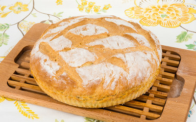 Freshly baked homemade bread on bread board.