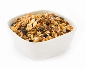 Morning breakfast with granola in a bowl isolated on white background. Side view.