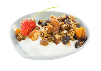 Morning breakfast with greek yogurt, granola and whole fresh strawberry in a bowl isolated on white background. Side view.