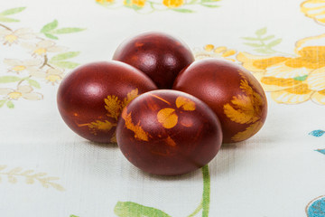 Easter eggs colored in onion peelings and some grass used for decoration.