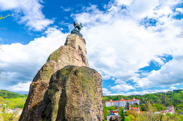 Chamois Statue Socha Kamzika at Deer Jump Jeleni Skok Lookout with Karlovy Vary (Carlsbad) colorful...