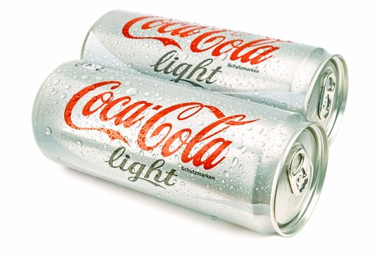NIEDERSACHSEN, GERMANY APRIL 9, 2017:Two cans of wet coca cola light on a white background