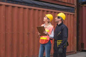 Warehouse logistic staffs checking postion on layout Containers box of documents at from Cargo freight ship at Cargo container shipping