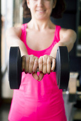 Fototapeta na wymiar Thin thirties woman doing exercise in the gym