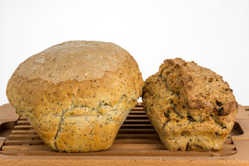 Two home made bread loafs one with chia seeds and other with onions and beef.