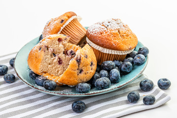 Blueberry Muffins and fresh blueberries on a blue plate