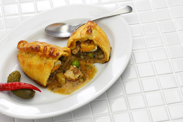 homemade saltena, empanada with a juicy filling, Bolivian breakfast