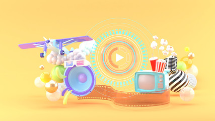 Play icon is surrounded by speakers, TV,Pop corn, microphones and airplanes among colorful balls on an orange background.-3d rendering.