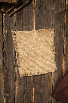 burlap napkin on wooden background in country rustic style