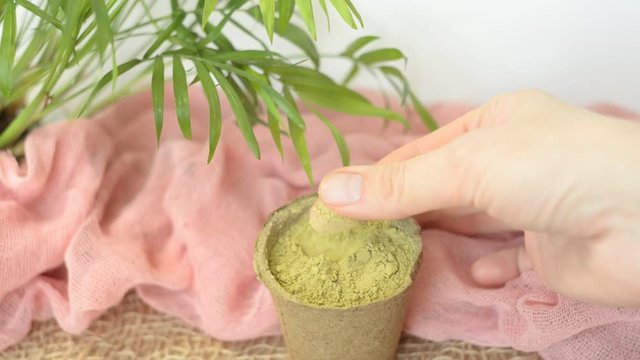 dry henna powder with female hands to rub without manicure. Natural materials. Eyebrow dyeing without chemistry. Pink tones