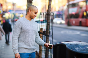 young man throwing his rubbish in the bin
