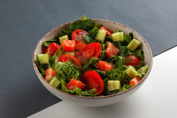 Salmon Salad with spinach, cherry tomatoes, corn salad, fresh mint and basil. Concept for a tasty and healthy meal.