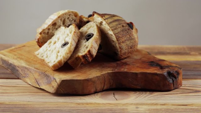 Wooden bread boards with various types of sliced bread.