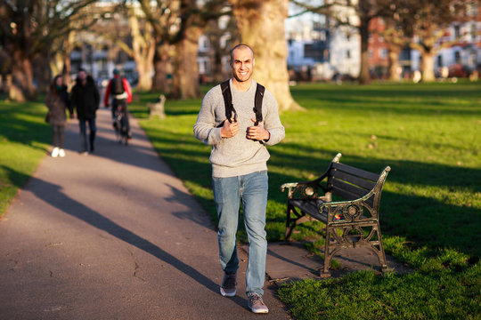 young man walking in the park.