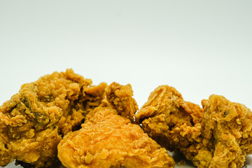 Deep fried chicken shot on a white isolated background.