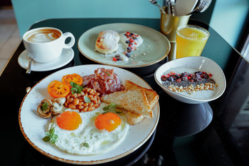 Dish breakfast dinner time plate table black coffee juice musli eggs bread cheesecakes porridge macaroni water menu for cafe restaurant 