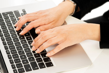 Closeup on the hands of a businesswoman working with notebook