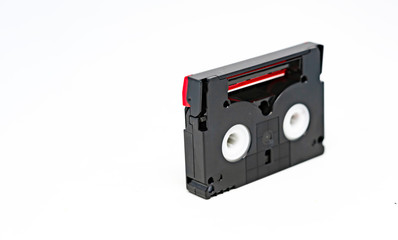 side view of a Mini DV format video cassette isolated on a white background