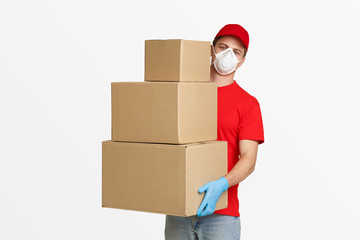 Postman in protective mask and gloves holds many parcels