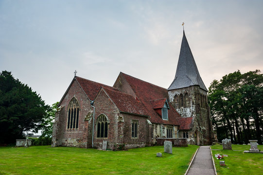 All Saints church in Herstmonceux, East Sussex, England. Brick Herstmonceux castle in England (East Sussex) 15th century. Birds of prey and view of moated brick castle in Southern England.