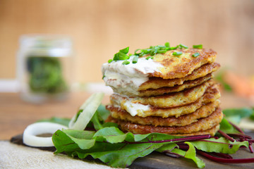potato patties stacked with fresh herbs.