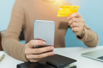 businesswoman hand typing security code on digital mobile smart phone and payment with credit card on desk at home office, digital marketing, work from home, shopping online, technology concept