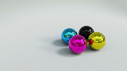 Druckfarben als Chrom Kugeln auf grauem Untergrund 4C Vierfarbdruck