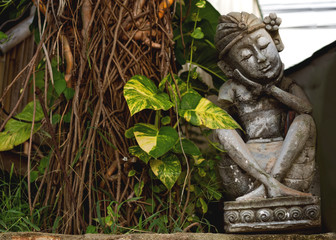 bali buddha statue in jungle hot spring temple