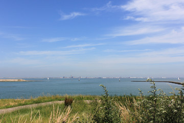 Fototapeta na wymiar Mouth of the Scheldt River with the city of Vlissingen in the background during summer