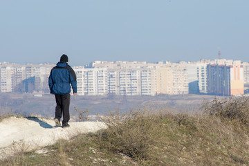 A lone traveler is on his way to the city. Outdoor activities such as walking.