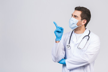 Doctor man in medical gown sterile face mask gloves isolated on white background. Epidemic pandemic...