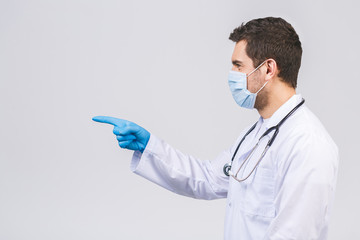 Doctor man in medical gown sterile face mask gloves isolated on white background. Epidemic pandemic...