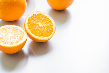 slice orange and oranges on a white background