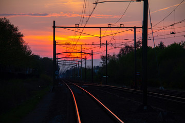 Fototapeta na wymiar Sunset at over the railroad with reflective rails