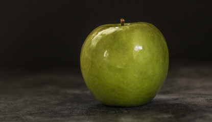 Juicy fresh green apple on a dark background with space for text. Banner