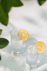 Two glasses of water with lemon. Summer refreshing. Lemonade