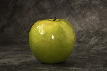 Juicy fresh green apple on a dark background with space for text. Banner
