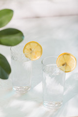 Two glasses of water with lemon. Summer refreshing. Lemonade