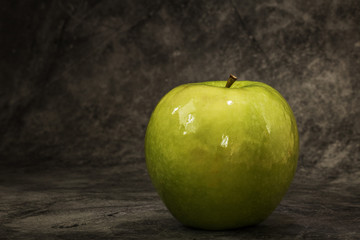 Juicy fresh green apple on a dark background with space for text. Banner