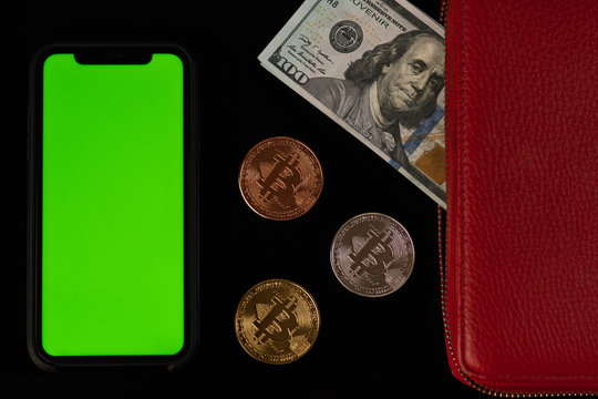 Phone with green screen, bitcoin coins and wallet with dollar bill isolated on white background
