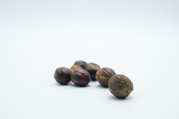 Buah pala or nutmeg shot on a white isolated background.