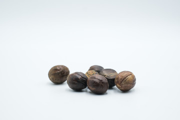 Buah pala or nutmeg shot on a white isolated background.