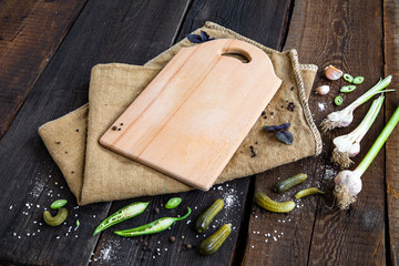 delicious ingredients and empty wooden cutting board for healthy vegetarian cooking, vegan food concept. Copy space.