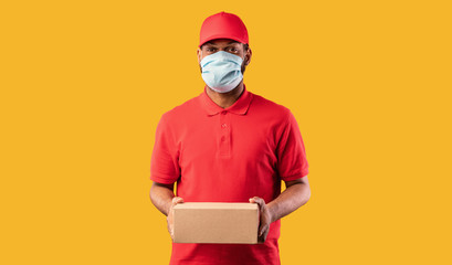 Fototapeta na wymiar African Courier Guy Holding Cardboard Box Delivering Parcel, Studio Shot
