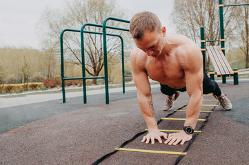Fototapeta premium Sport. Young athletic man doing push-ups. Muscular and strong guy exercising.