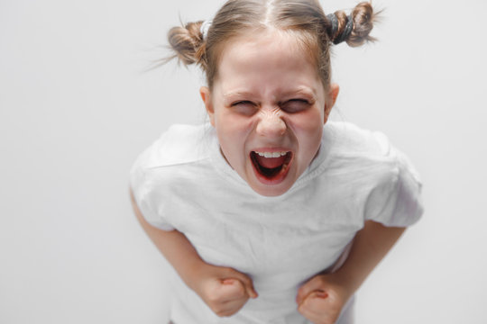 little girl screaming at the camera, white background, child&rsquo;s tantrum