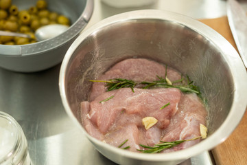 Turkey fillet being marinated with garlic and rosemary